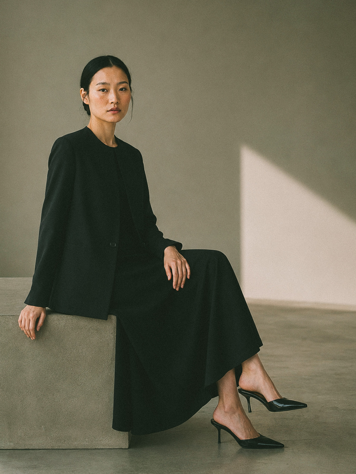 Womenswear uniform jacket and long skirt, worn seated
