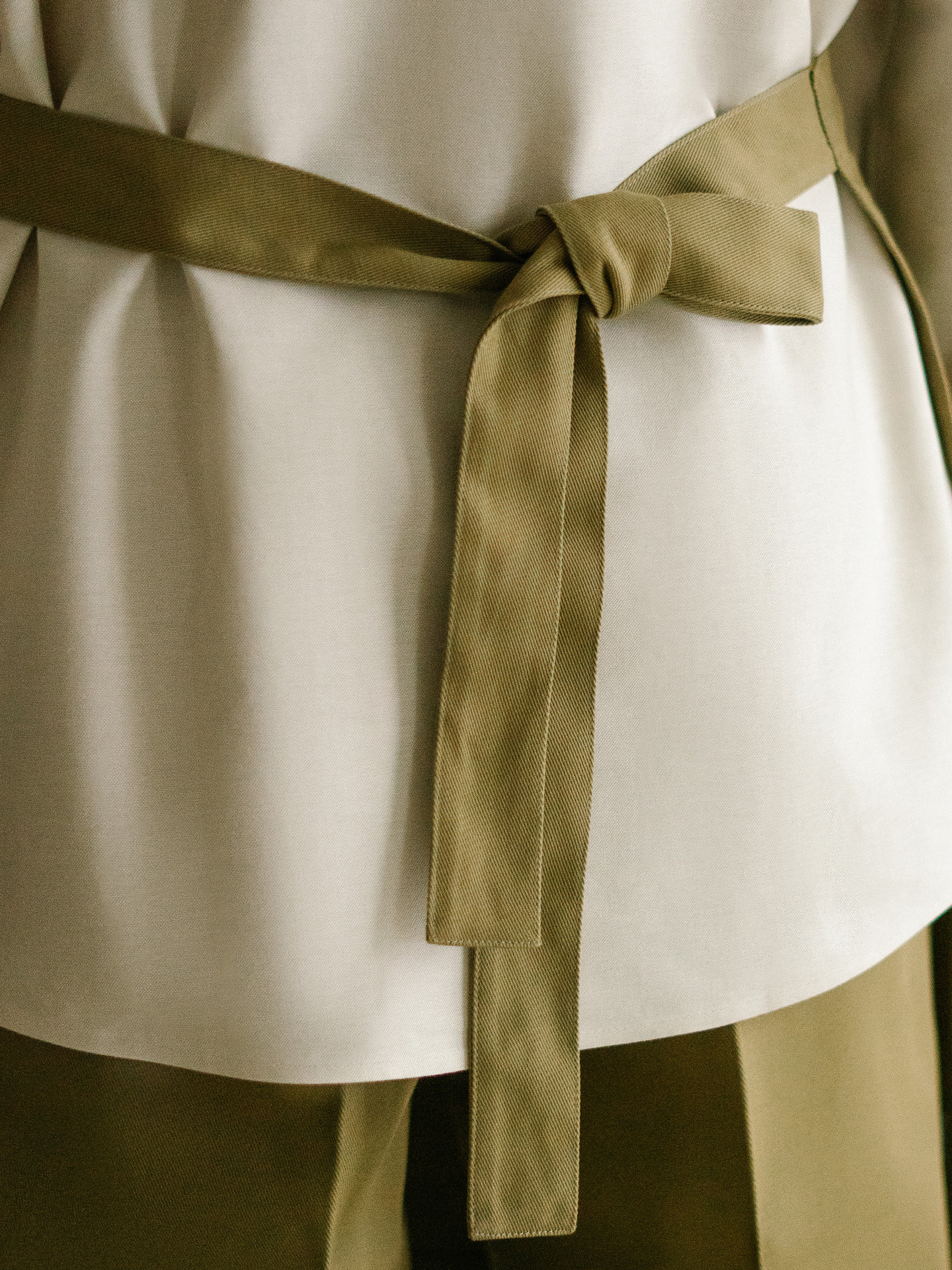 The apron waist tie, knotted at the front