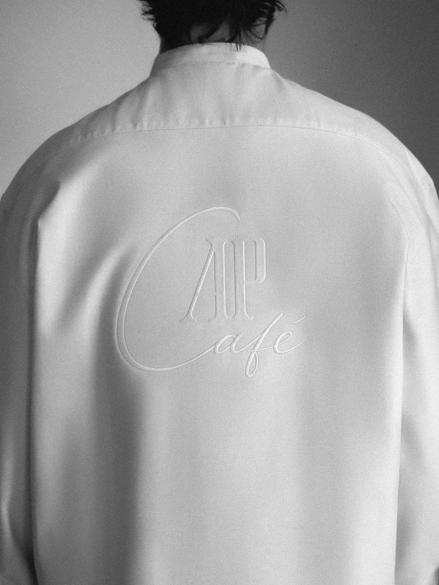 Tonal AP Café embroidery on the back of the service shirt