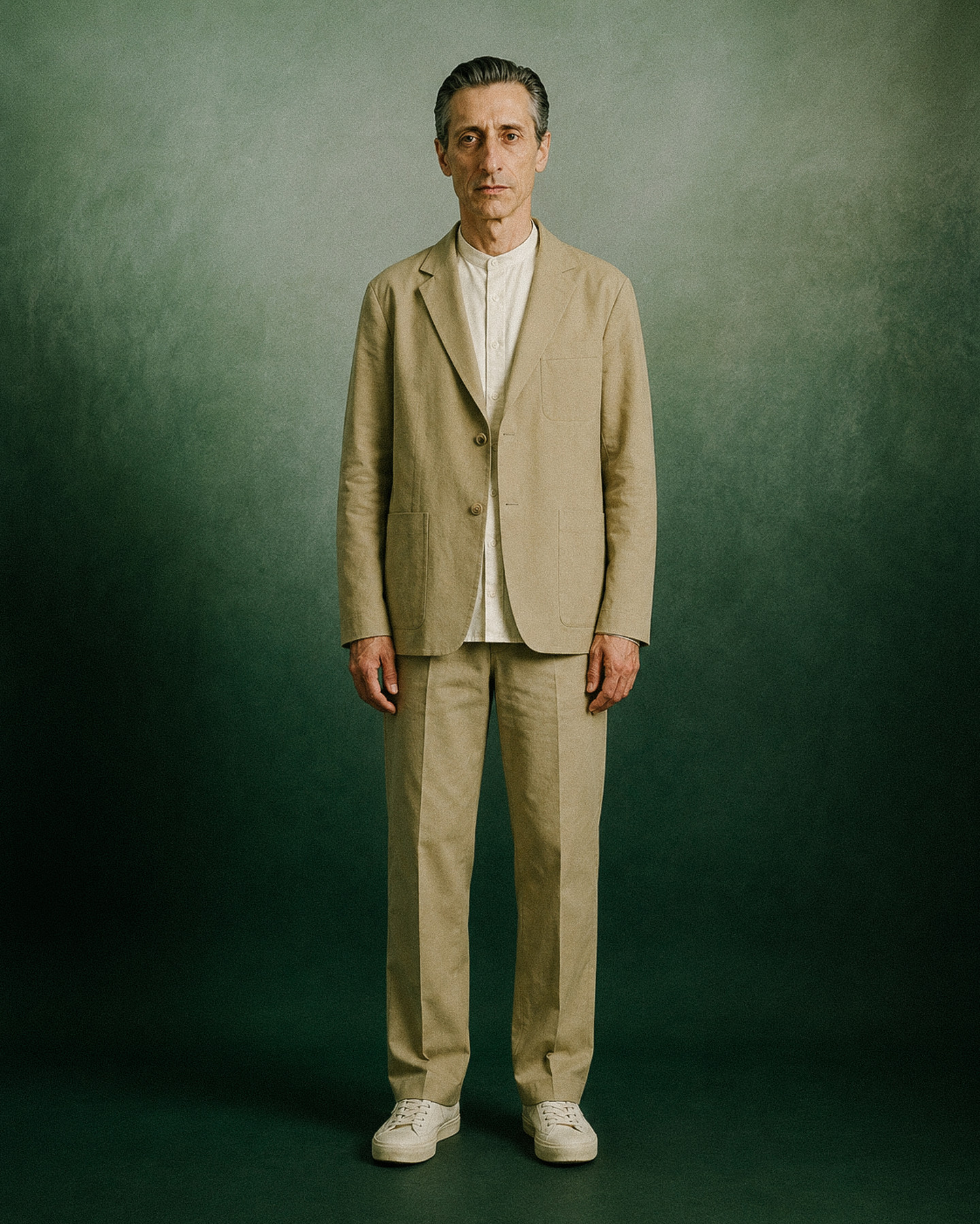 The host role — unstructured jacket and trousers over a cream shirt