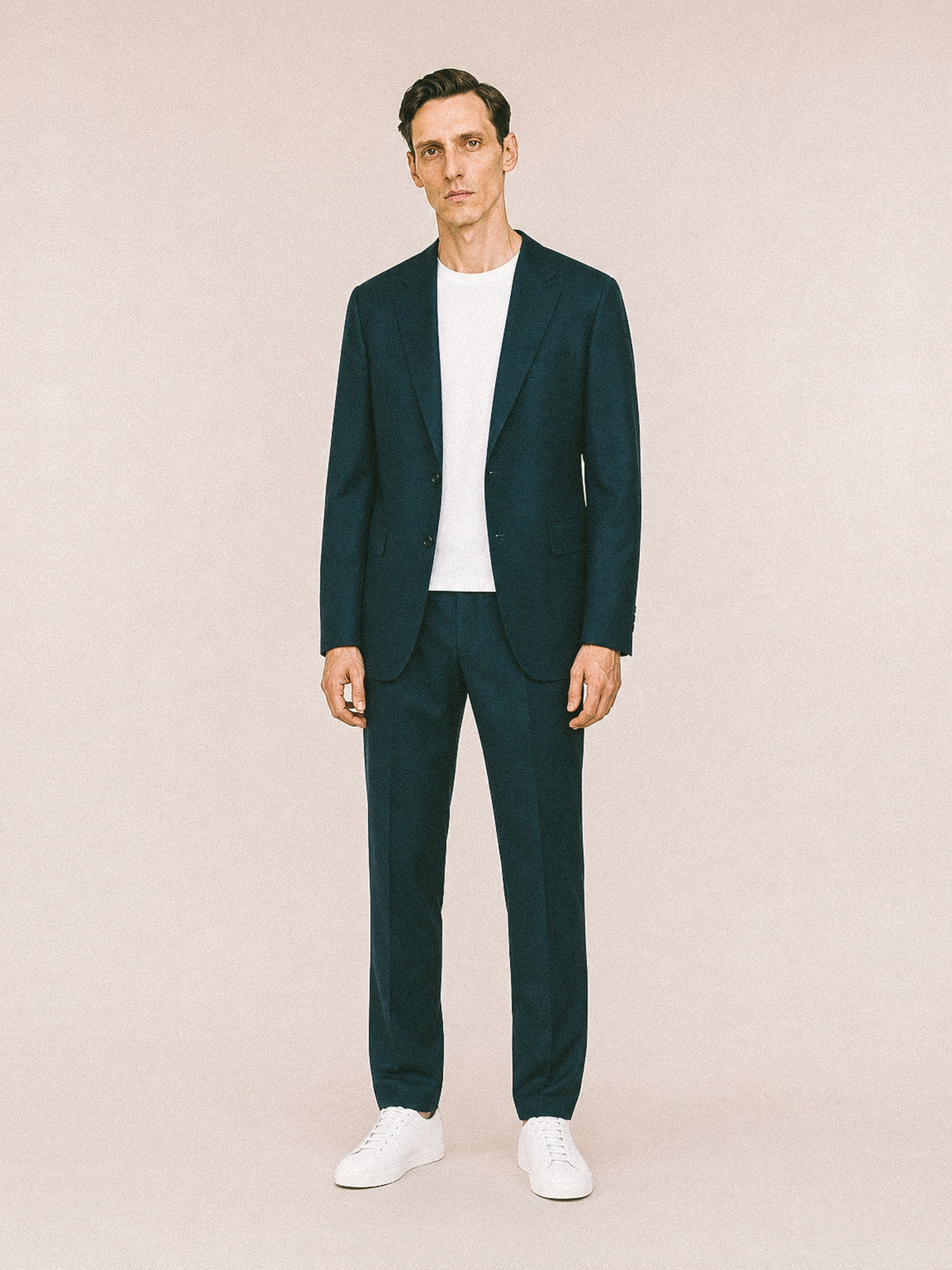 Menswear uniform — navy suit worn with a white tee