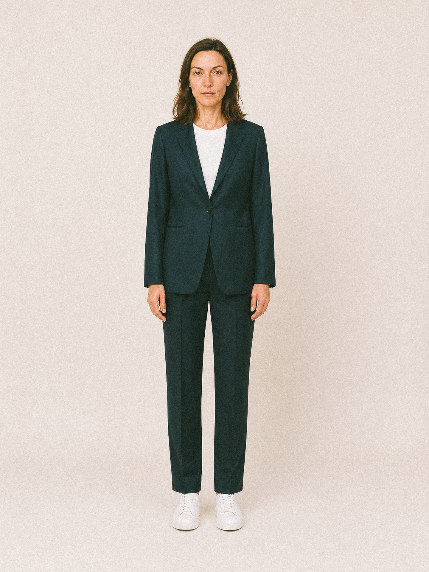 Womenswear uniform — navy suit worn with a white tee